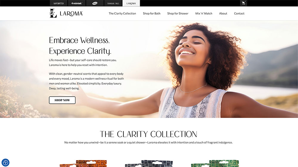 A woman with outstretched arms smiles outdoors in a field. The website header reads LAROMA with navigation links. Text overlay says, Embrace Wellness. Experience Clarity. and promotes wellness products. A Shop Now button is visible.