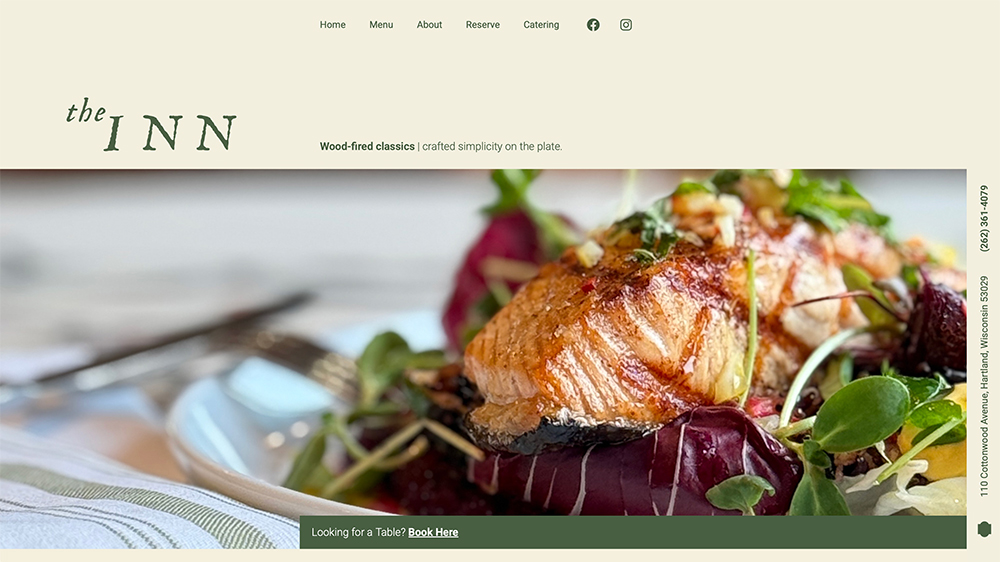 A close-up of a plated dish featuring a piece of grilled salmon on top of a salad with greens and vegetables, set on a table. The website banner reads the INN with navigation links at the top.